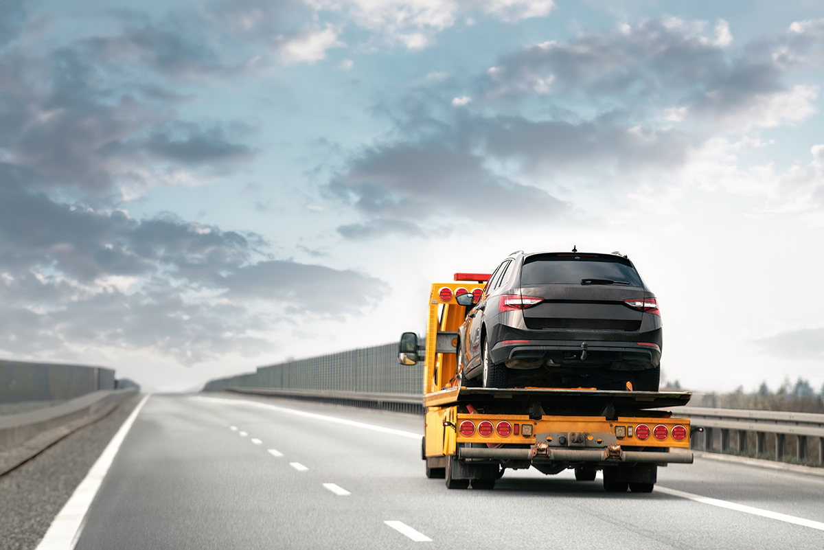 A tow truck carrying a car